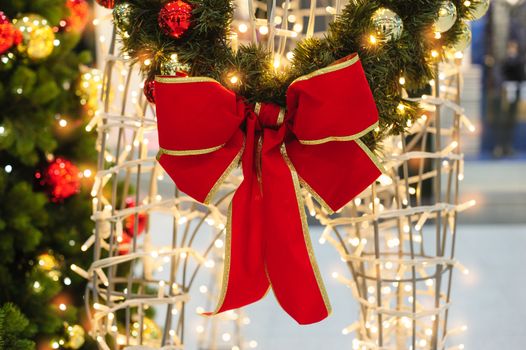 Red bow on the Christmas tree in the Park.