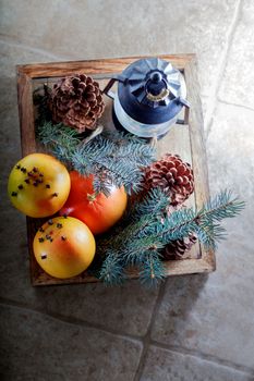 Christmas oranges in wooden box on a stone surface