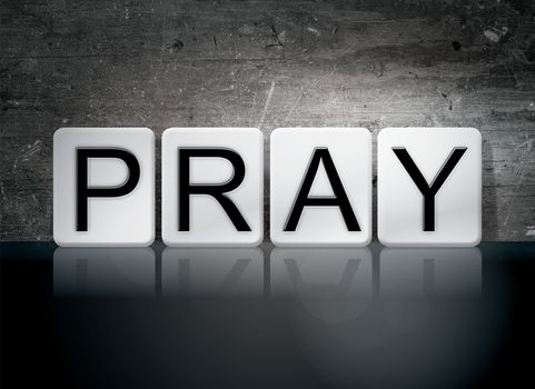 The word "Pray" written in white tiles against a dark vintage grunge background.