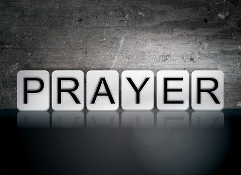 The word "Prayer" written in white tiles against a dark vintage grunge background.