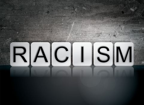 The word "Racism" written in white tiles against a dark vintage grunge background.