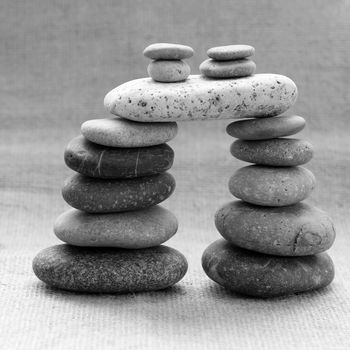 Amazing arrangement to make tower from pebble, two stack of stones and more boulder to illustration for bond in family relationship or burden of debt