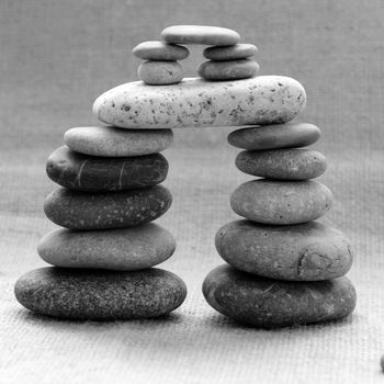 Amazing arrangement to make tower from pebble, two stack of stones and more boulder to illustration for bond in family relationship or burden of debt