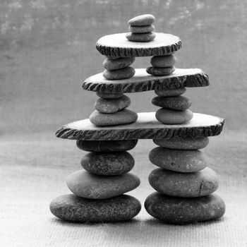 Amazing arrangement to make tower from pebble, two stack of stones and more boulder to illustration for bond in family relationship or burden of debt