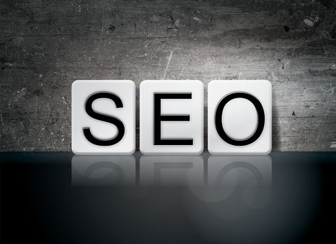 The word "SEO" written in white tiles against a dark vintage grunge background.