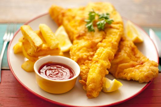 Two pieces of battered fish on a plate with chips