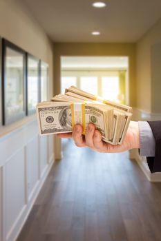 Male Hand With Stack of Cash Inside Hallway of New House.