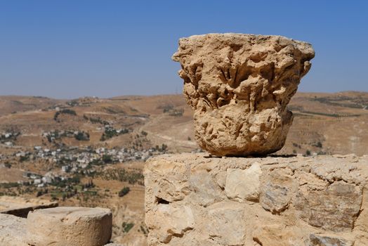 Weathered column capital on the ruins of medieval Kerak castle in Jordan