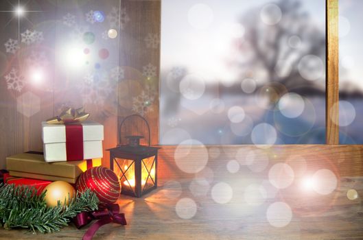 Christmas gifts and decorations next to a window with snow covered landscape outdoors 