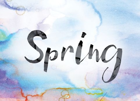 The word "Spring" painted in black ink over a colorful watercolor washed background concept and theme.