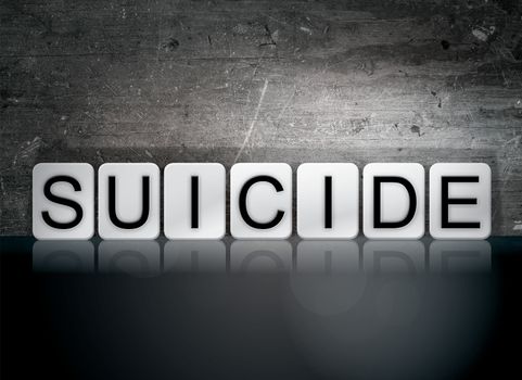 The word "Suicide" written in white tiles against a dark vintage grunge background.