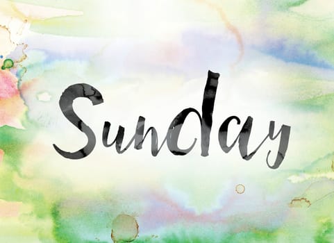 The word "Sunday" painted in black ink over a colorful watercolor washed background concept and theme.