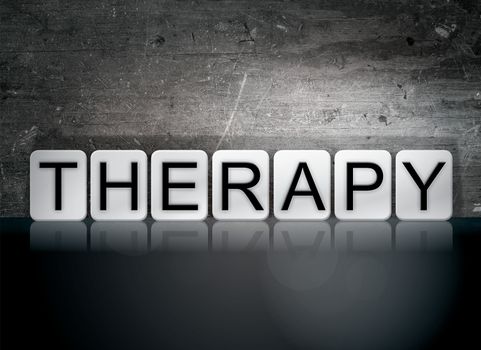 The word "Therapy" written in white tiles against a dark vintage grunge background.