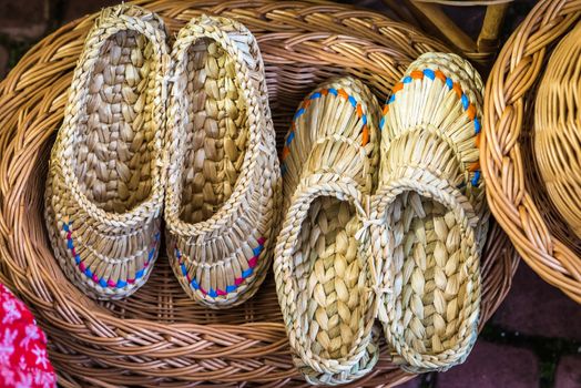 handmade braided sandals in the wickerwork hamper at the exhibition