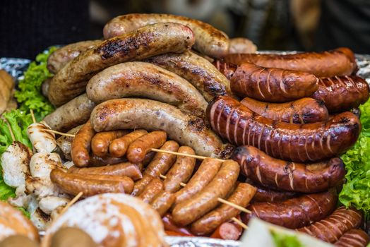 delicious Fried different kinds of sausages on a board