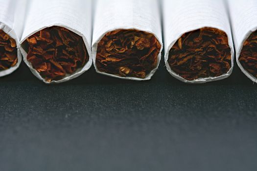 Closeup of cigarettes on black wooden table