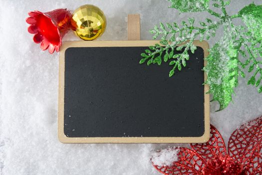 Blank blackboard on snow with Christmas decoration use for background