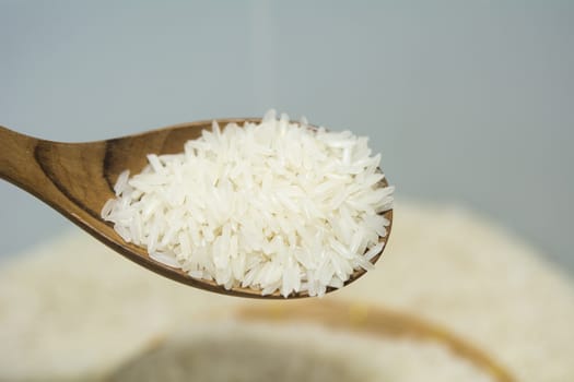 Pouring thai jasmine rice from wooden spoon