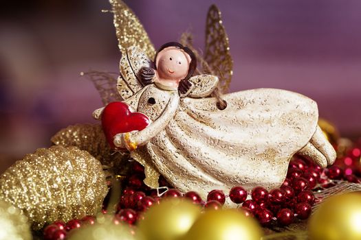 vintage toy angel.Angel toy with a heart in hand on a Christmas background. Christmas card. Christmas decoration.