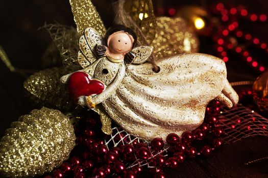 vintage toy angel.Angel toy with a heart in hand on a Christmas background. Christmas card. Christmas decoration.