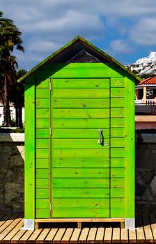 Beautiful green wooden beach cabin. Vertical image.