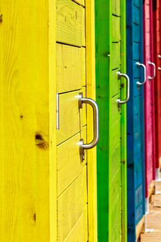 Beautiful colorful beach cabins closeup. Vertical image.