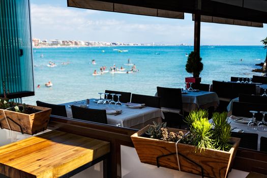 Restaurant on the seashore with the table set. Horizontal image.