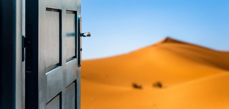 Opened door concept to beautiful and imaginary desert landscape