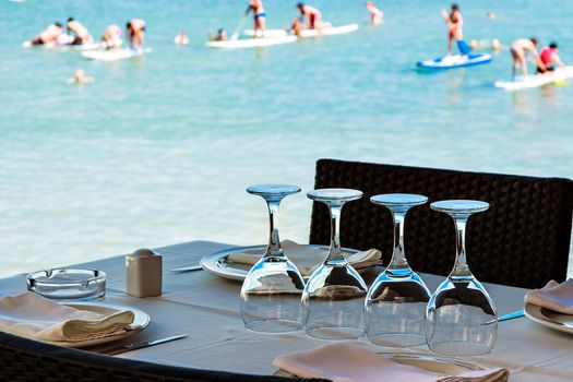 Restaurant on the seashore with the table set. Horizontal image.