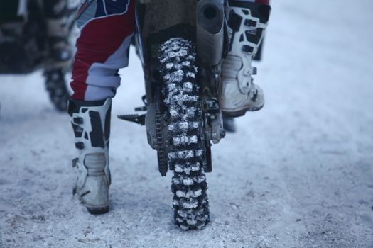 winter motocross racer motorcyclist at the start of the race