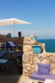 Restaurant with summer terrace and sea views. Vertical image.