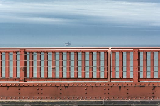 Golden Gate Bridge parapet with a ship on the background