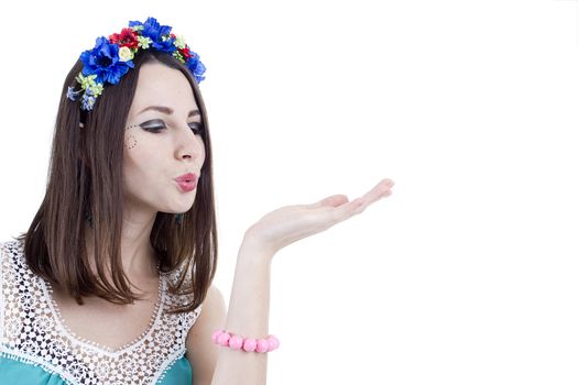 Portrait of a girl in a wreath of flowers on a white background