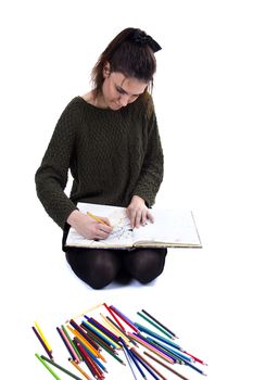 Young girl artist drawing pencils on white background