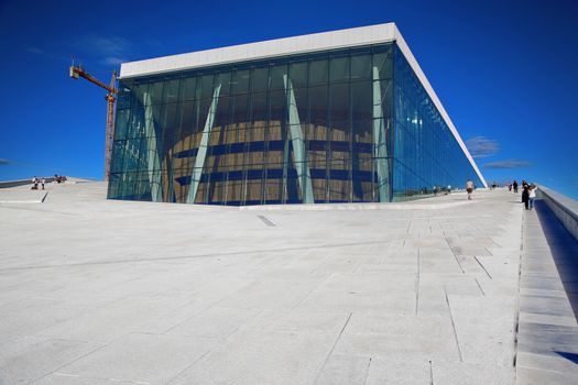 OSLO, NORWAY – AUGUST 17, 2016: Tourist on the Oslo Opera House which is home of Norwegian National Opera and Ballet and National Opera Theatre in Oslo, Norway on August 17,2016.