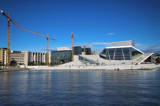 OSLO, NORWAY – AUGUST 17, 2016: Tourist on the Oslo Opera House which is home of Norwegian National Opera and Ballet and National Opera Theatre in Oslo, Norway on August 17,2016.