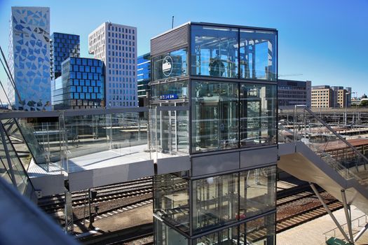 OSLO, NORWAY – AUGUST 17, 2016: View of Akrobaten pedestrian bridge  with modern business architecture and elevator lift that leads to the railway station street in Oslo, Norway on August 17, 2016.