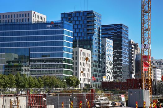 OSLO, NORWAY – AUGUST 17, 2016: A construction site of Bjorvika under construction in progress with a heavy vehicle and cranes in Oslo, Norway on August 17,2016.