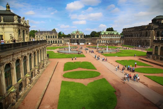 DRESDEN, GERMANY – AUGUST 13, 2016: Tourists walk and visit Dresdner Zwinger, rebuilt after the second world war, the palace is now the most visited monument  in Dresden, Germany on August 13, 2016.