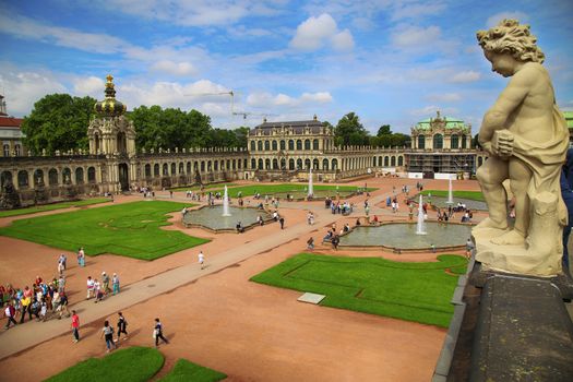 DRESDEN, GERMANY – AUGUST 13, 2016: Tourists walk and visit Dresdner Zwinger, rebuilt after the second world war, the palace is now the most visited monument  in Dresden, Germany on August 13, 2016.