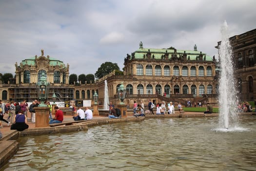 DRESDEN, GERMANY – AUGUST 13, 2016: Tourists walk and visit Dresdner Zwinger, rebuilt after the second world war, the palace is now the most visited monument  in Dresden, Germany on August 13, 2016.