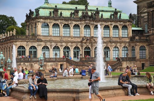 DRESDEN, GERMANY – AUGUST 13, 2016: Tourists walk and visit Dresdner Zwinger, rebuilt after the second world war, the palace is now the most visited monument  in Dresden, Germany on August 13, 2016.