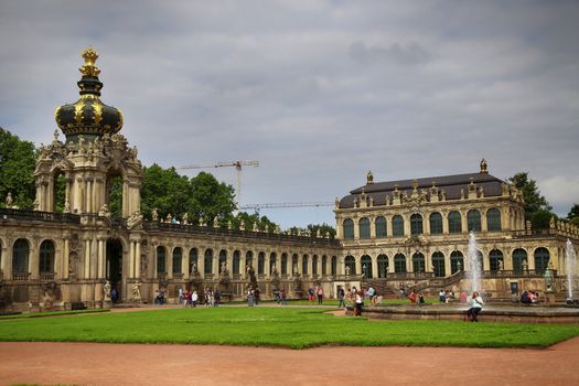 DRESDEN, GERMANY – AUGUST 13, 2016: Tourists walk and visit Dresdner Zwinger, rebuilt after the second world war, the palace is now the most visited monument  in Dresden, Germany on August 13, 2016.