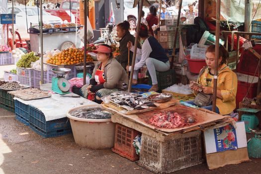 PAKXE, LAOS - FEBRUARY 25, 2016: People on the daily market of Pakxe on February 25, 2016 in Laos, Asia