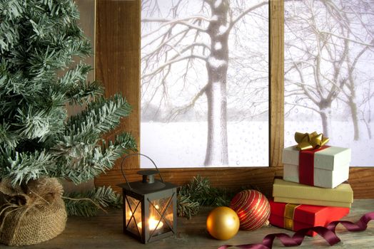 Christmas gifts and decorations next to a window with snow outdoors