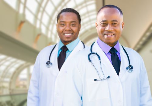 Two Handsome African American Male Doctors Inside Hospital Office.