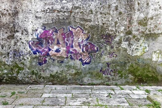 old wet street wall with graffiti