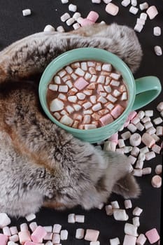 Hot chocolate with marshmallows and fur around.