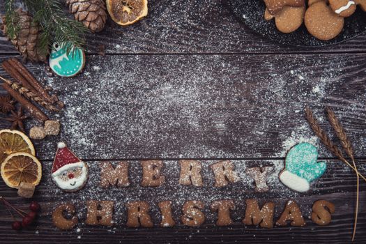 Different ginger cookies for new years and christmas on wooden background, top view