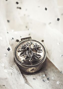 vintage metal forged round box with jewelery.